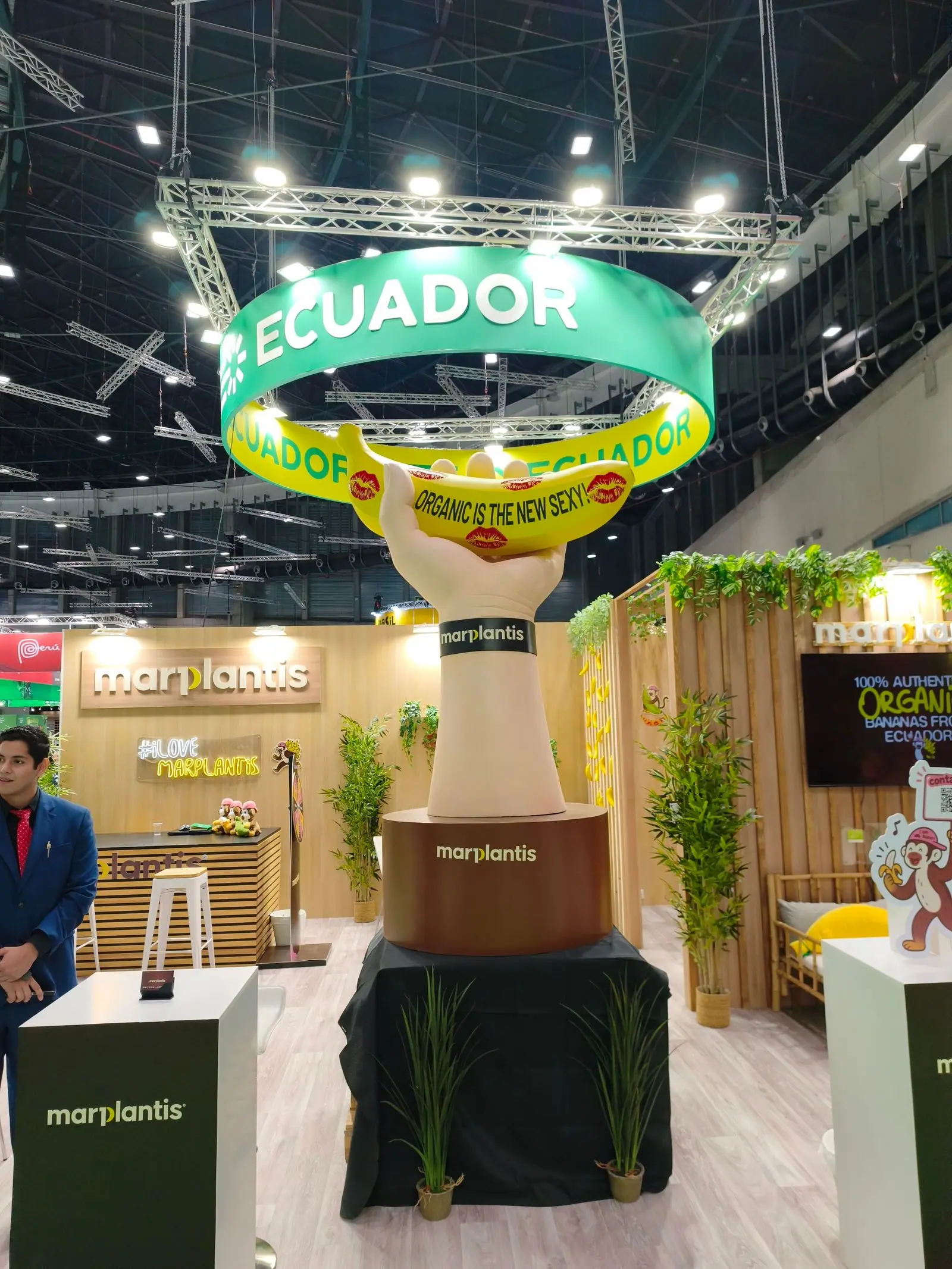 Mano gigante sosteniendo un plátano en el stand de Marplantis en una feria